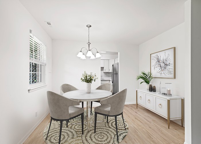A dining room with a white table and chairs at Springetts Apartments in York, Pennsylvania