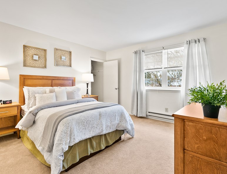 Bedroom with king sized bed at Grampian Hills Apartments in Williamsport, PA