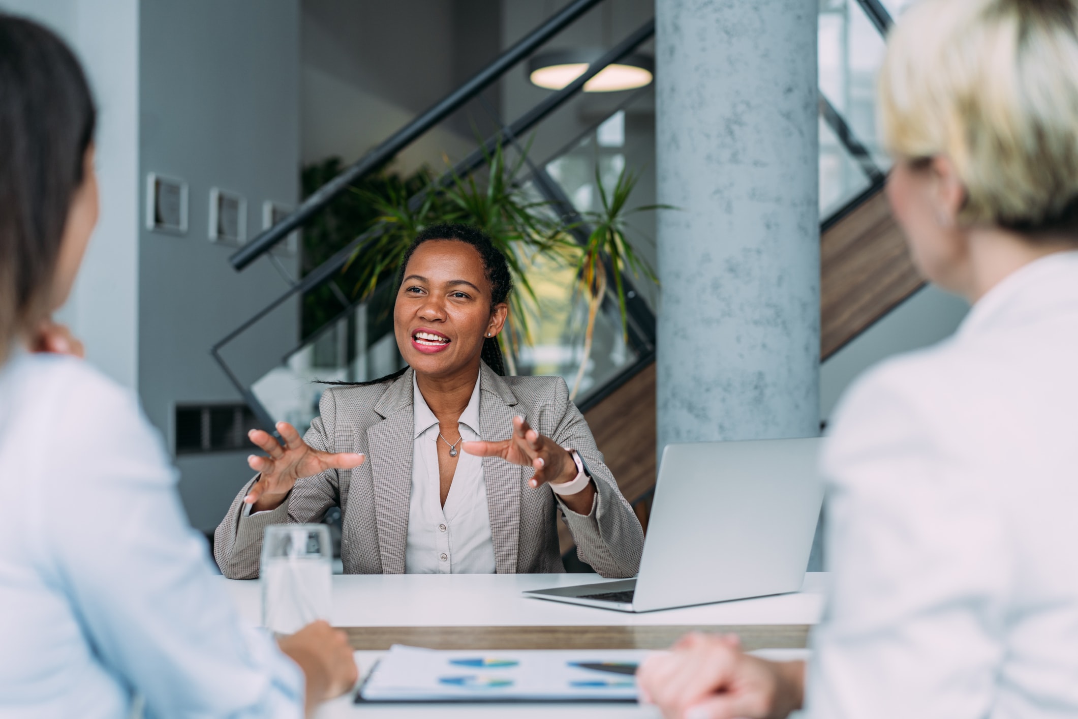 Company owner on a meeting with two of her employees in her office.