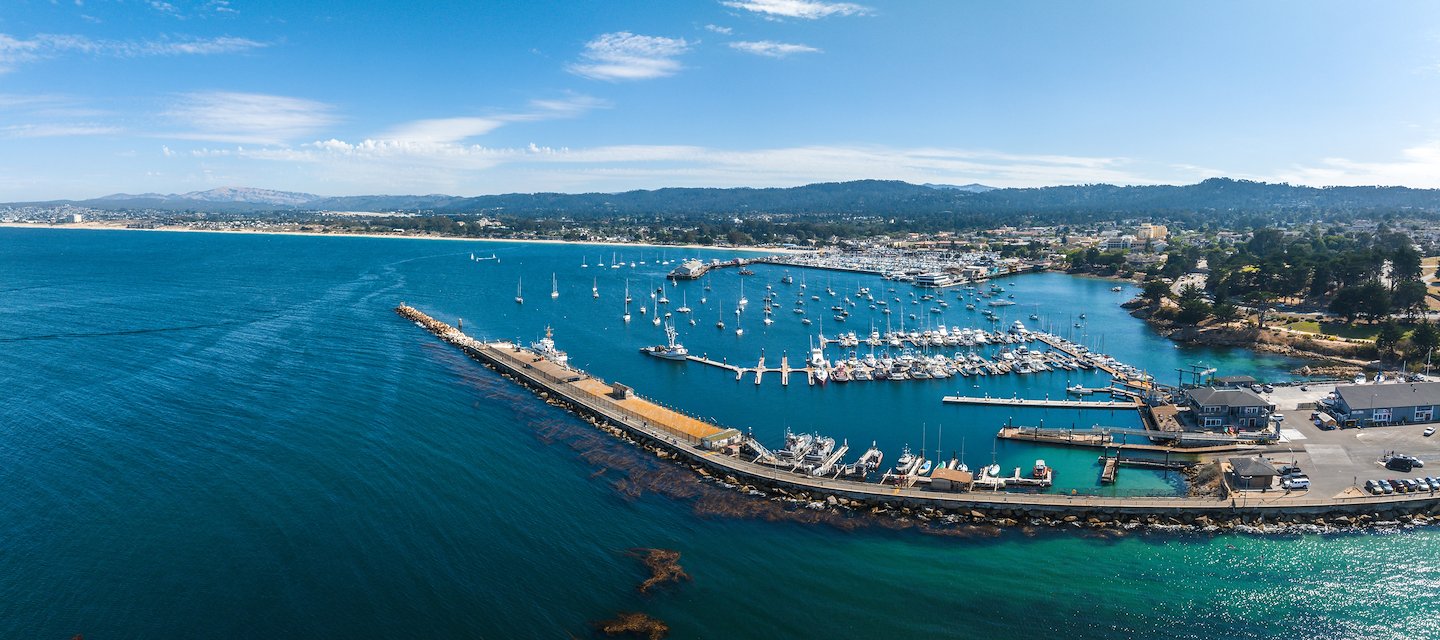 Aerial view of Monterey, CA harbor with boats and the Days Inn Monterey Fisherman's Wharf/Aquarium.