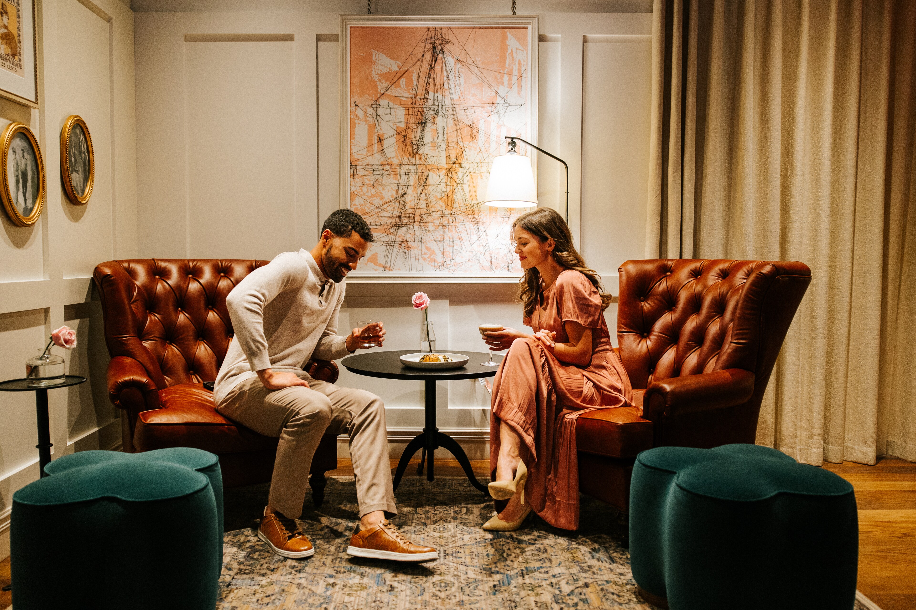 A couple enjoys drinks at Canopy by Hilton Boston Downtown in a cozy setting.