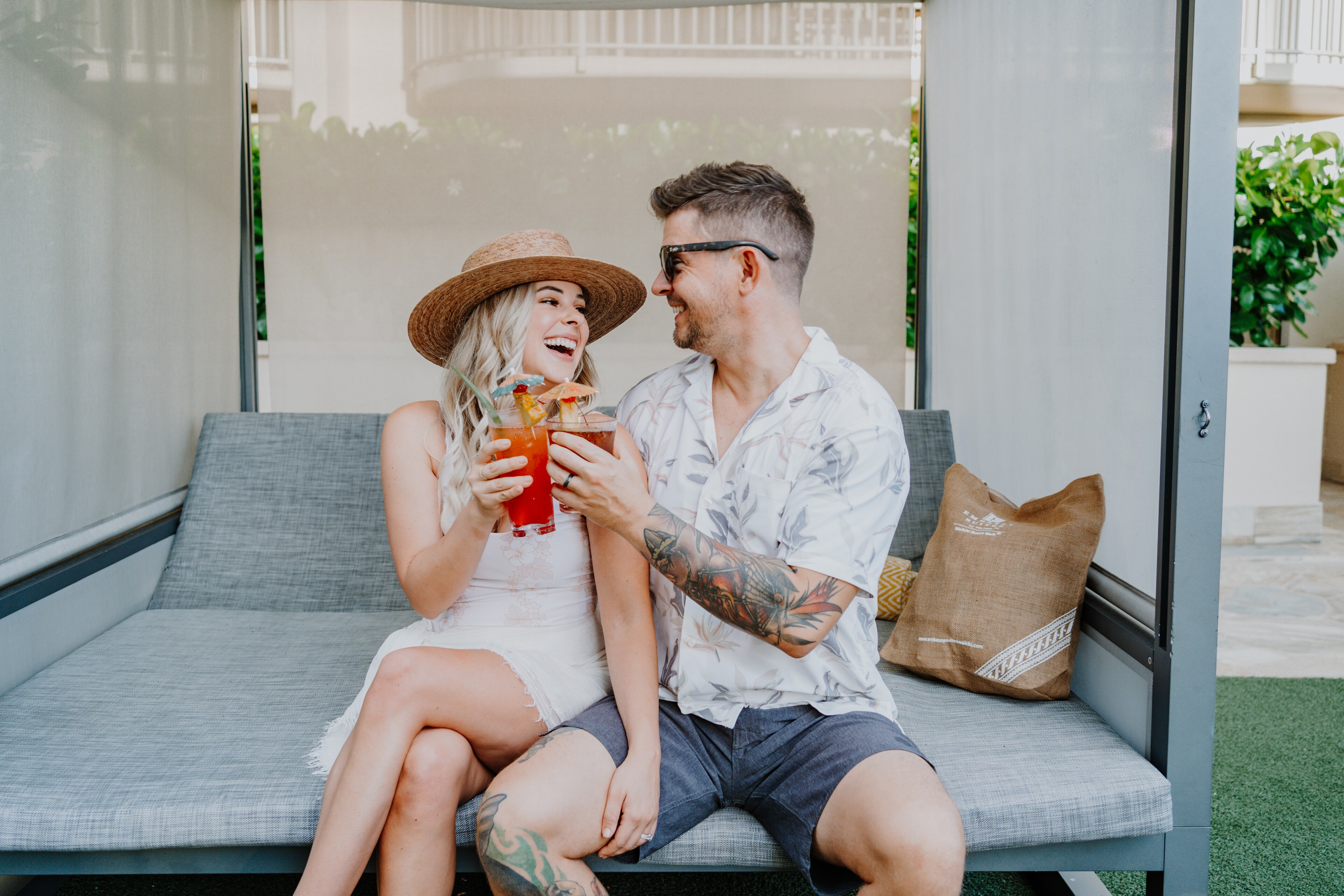 Couple enjoying drinks together at Waikiki Beach.