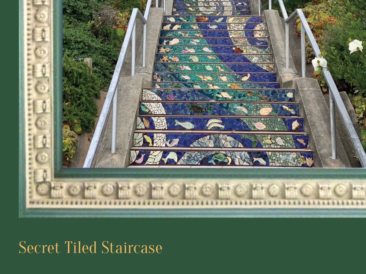 A staircase with mosaic tile steps and metal railings surrounded by greenery.