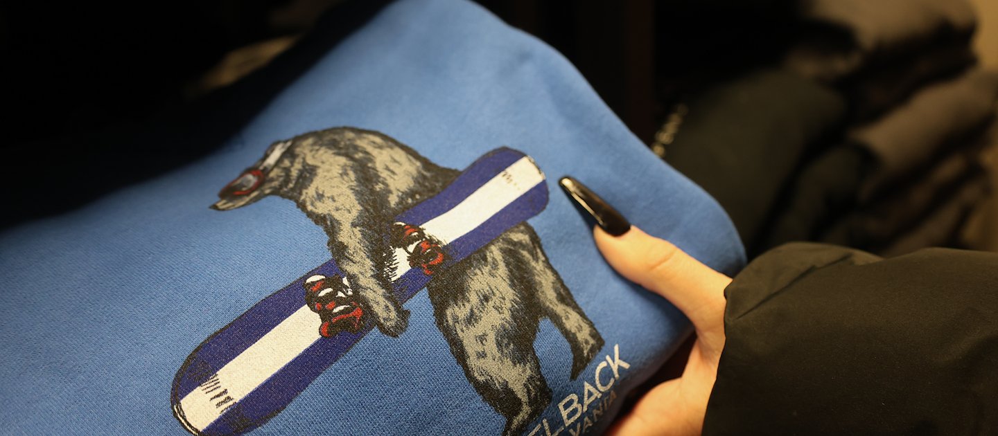 Person grabbing sweatshirt from Basecamp Retail.