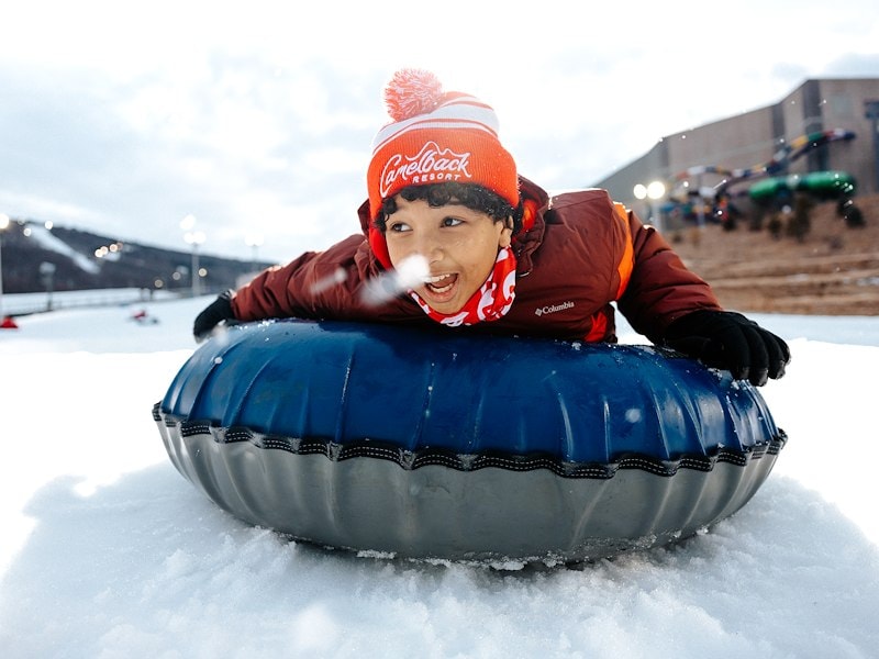 boy snow tubing at Camelback resort