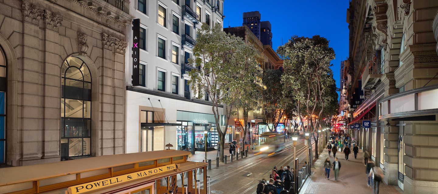 Axiom Hotel exterior at night with Powell St. Cable Car in foreground