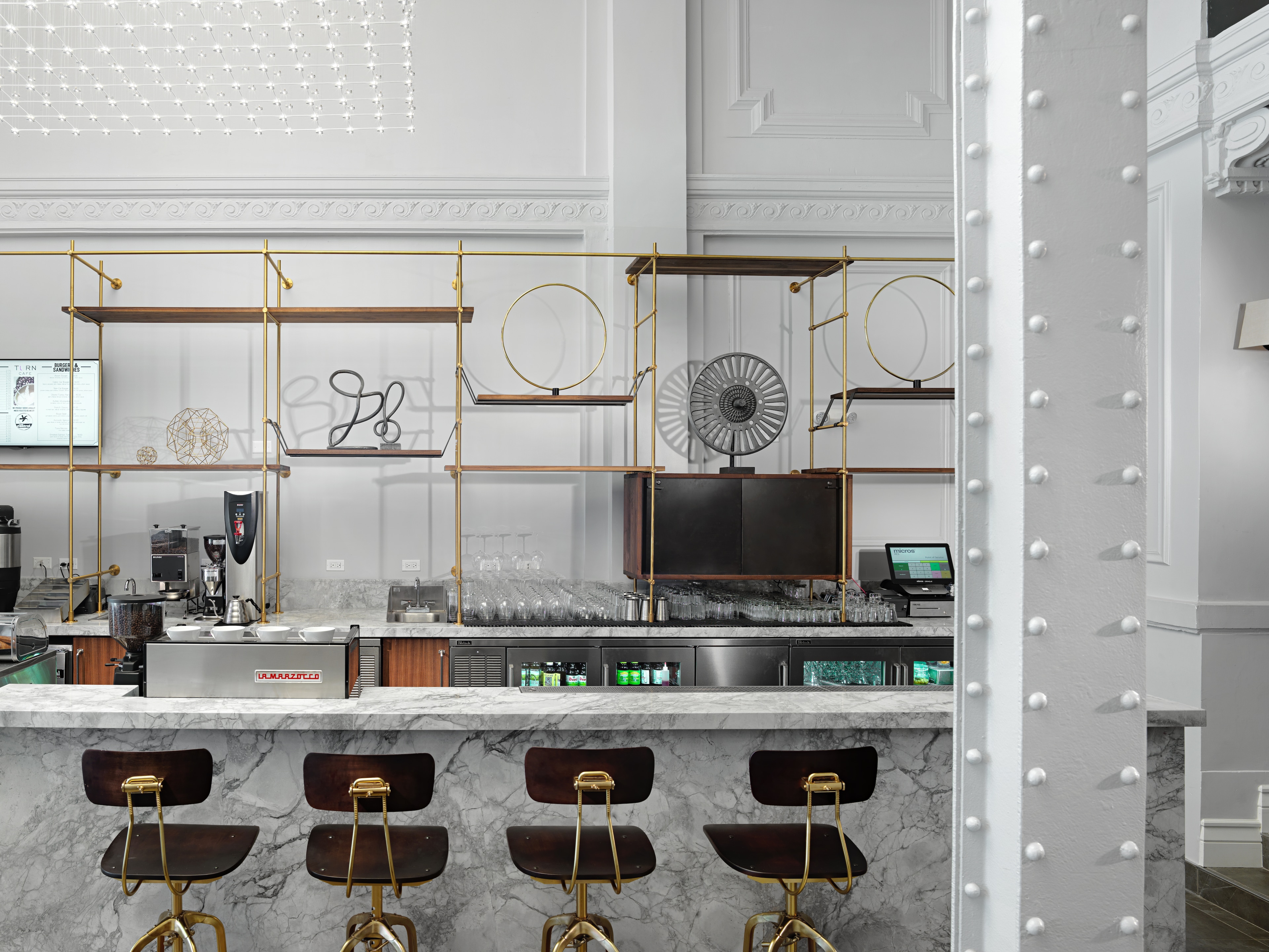 a bar with four stools and a marble countertop
