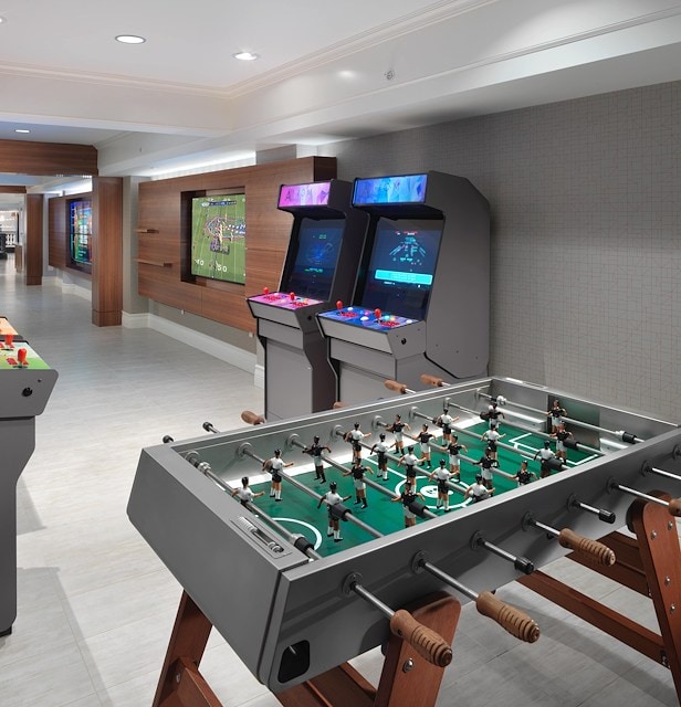 A lounge area with a foosball table and video games