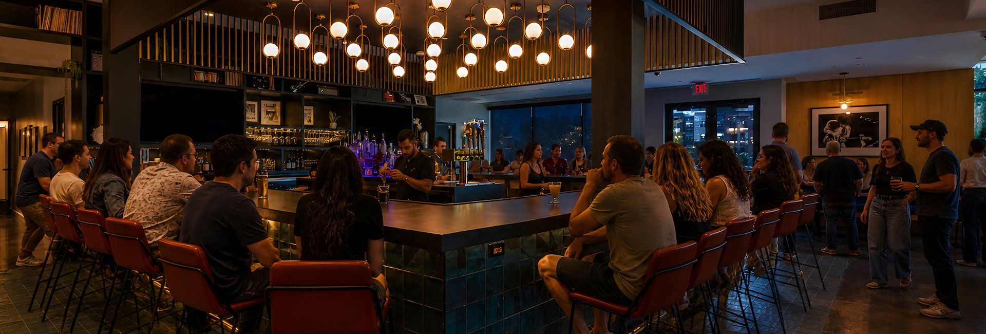 Guests enjoy drinks at the bar inside Backstage Bar & Grill in Austin, TX.