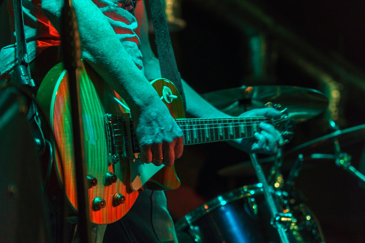 A guitarist performs live music at Backstage Bar & Grill in Austin, TX.