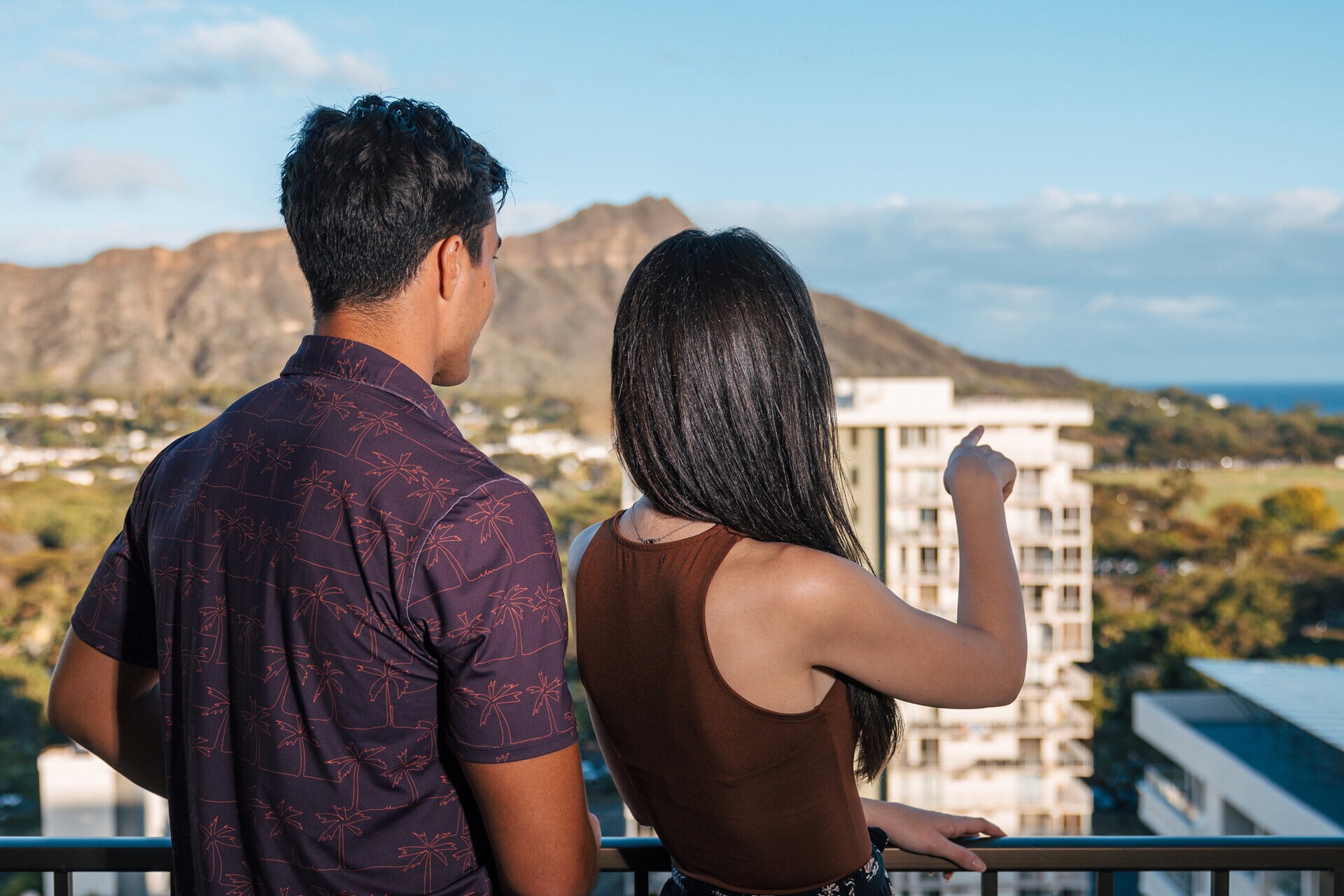 a man and woman looking at a city