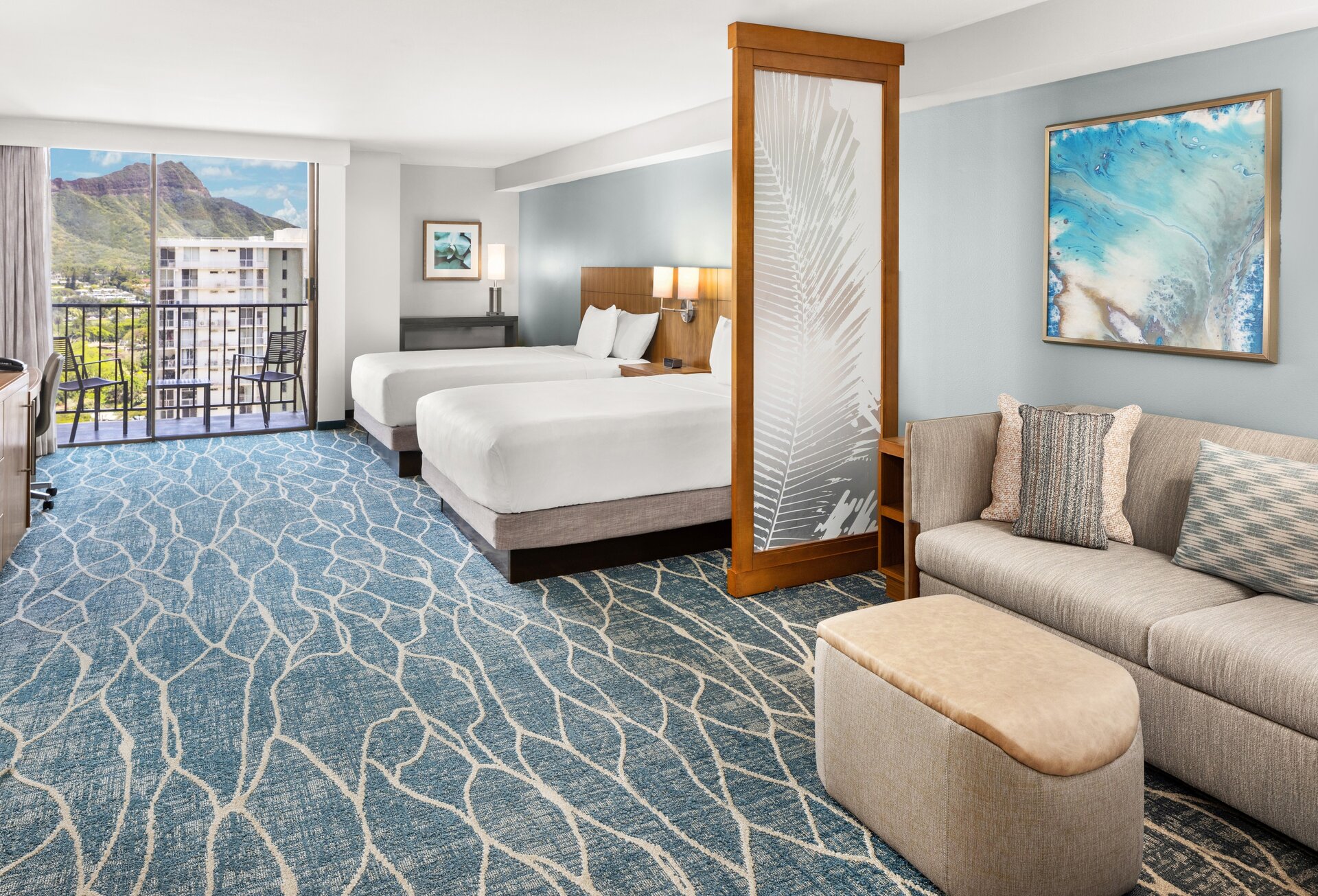a room with two beds and a couch