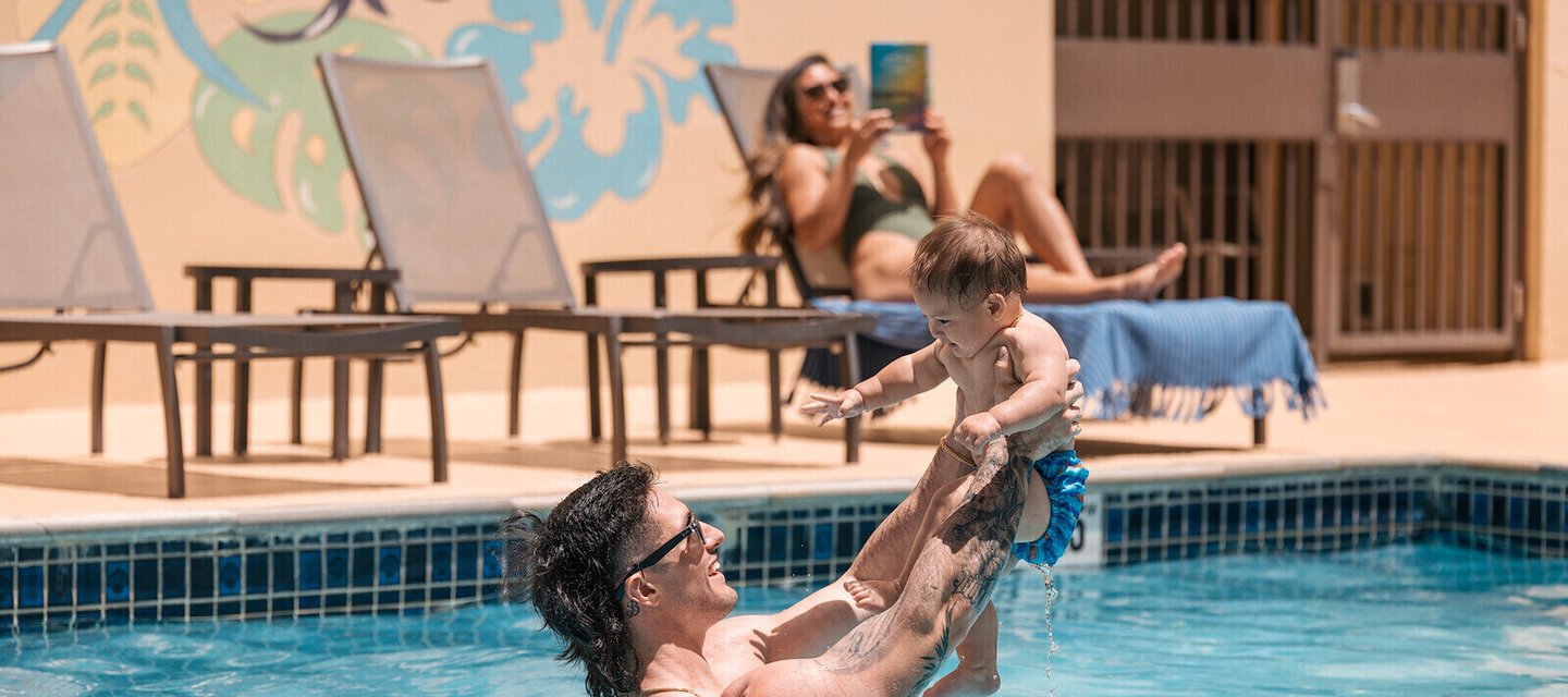 a man and his child in the pool at our Waikiki hotel