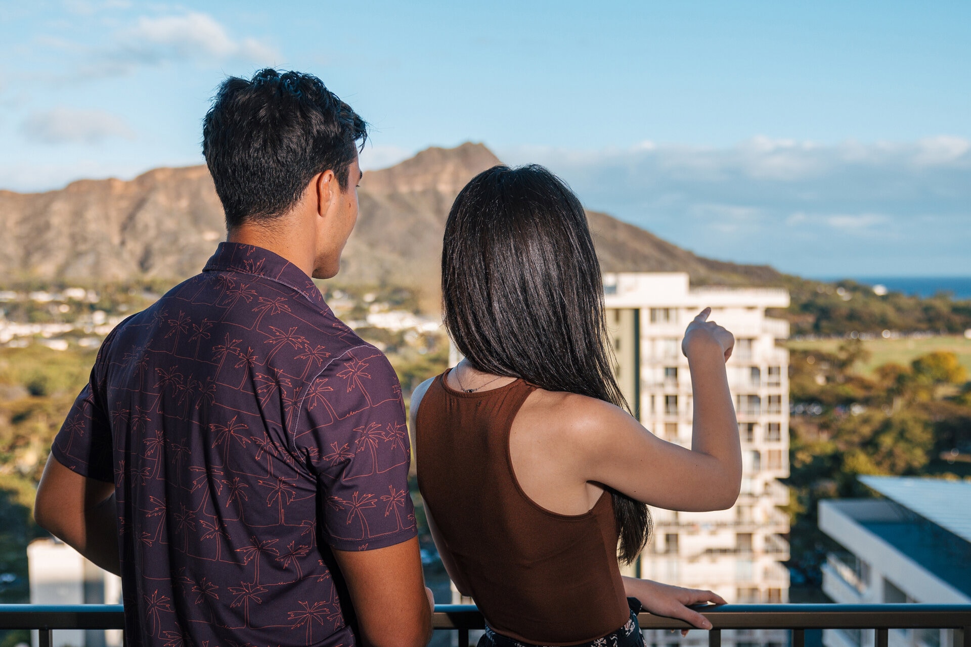 a man and woman looking at a city
