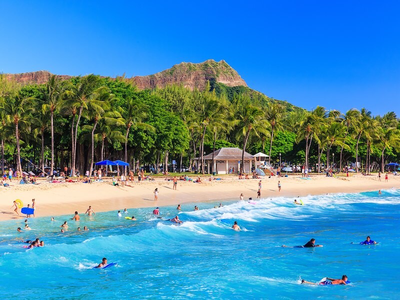 Waikiki beach with people swimming in the water