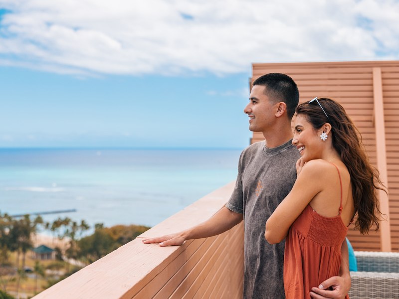 couple overlooking ocean view at Queen Kapiolani Hotel