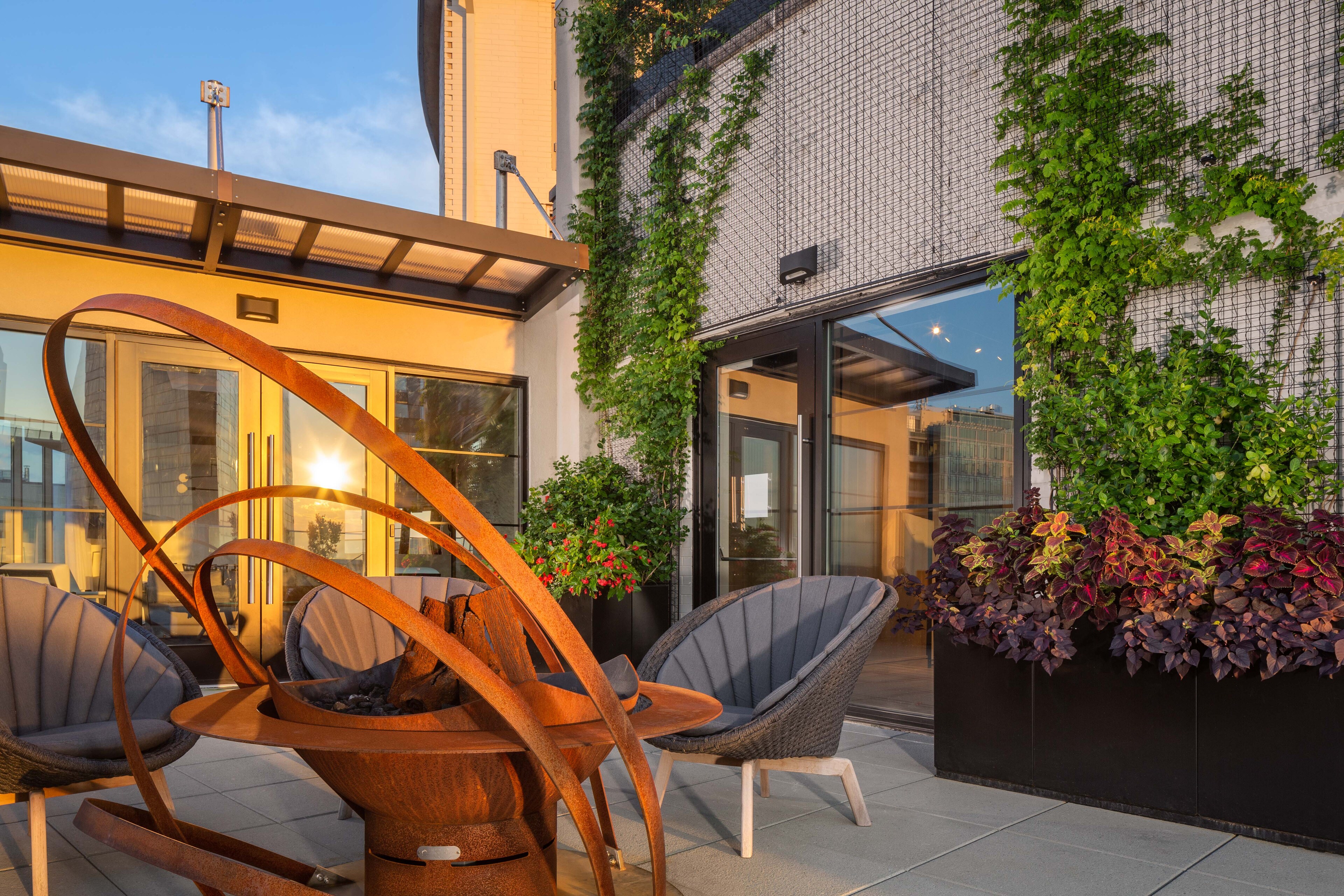 The terrace at The Windsor Suites features cozy seating and lush greenery.