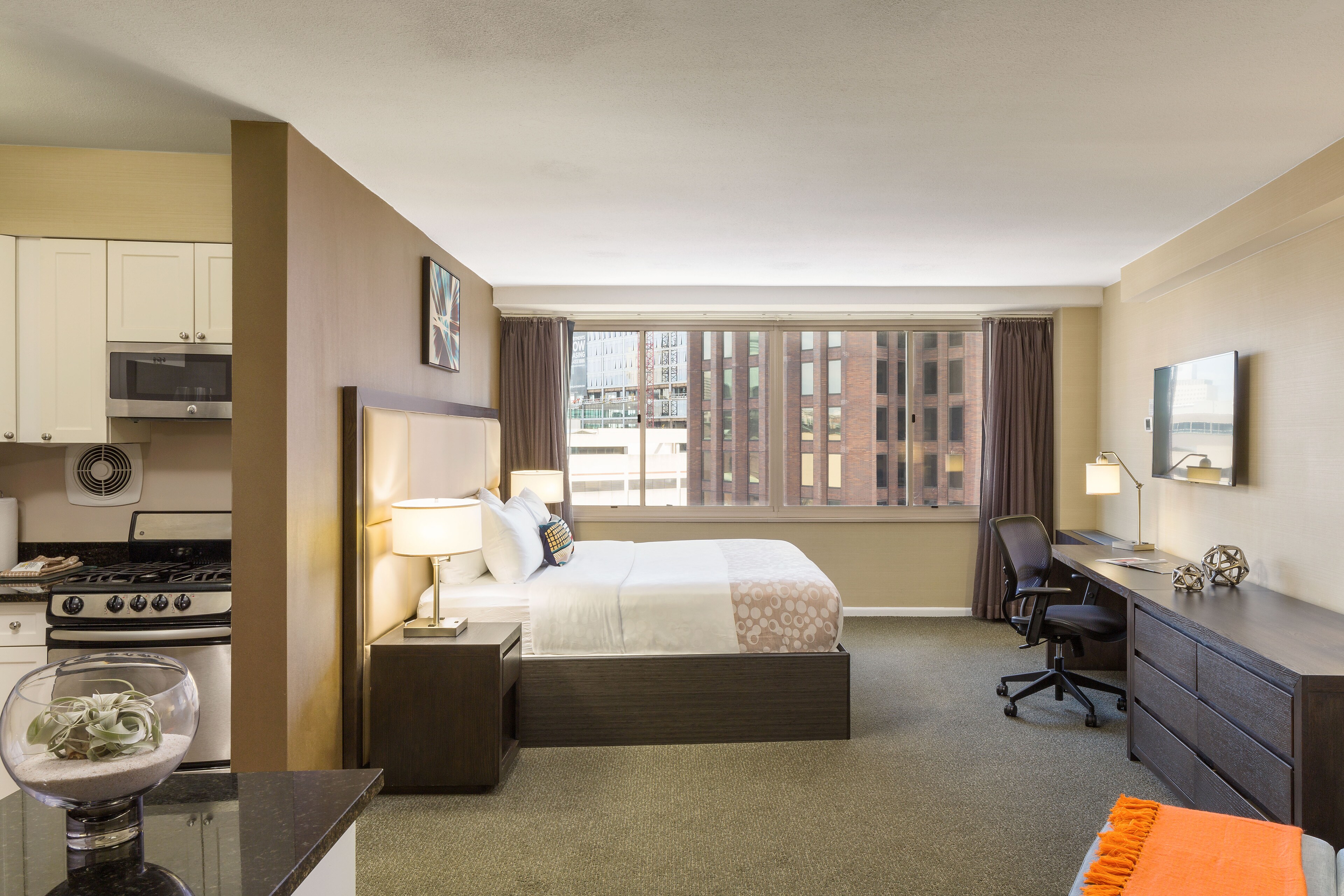 A modern studio room featuring city views at The Windsor Suites, Philadelphia.