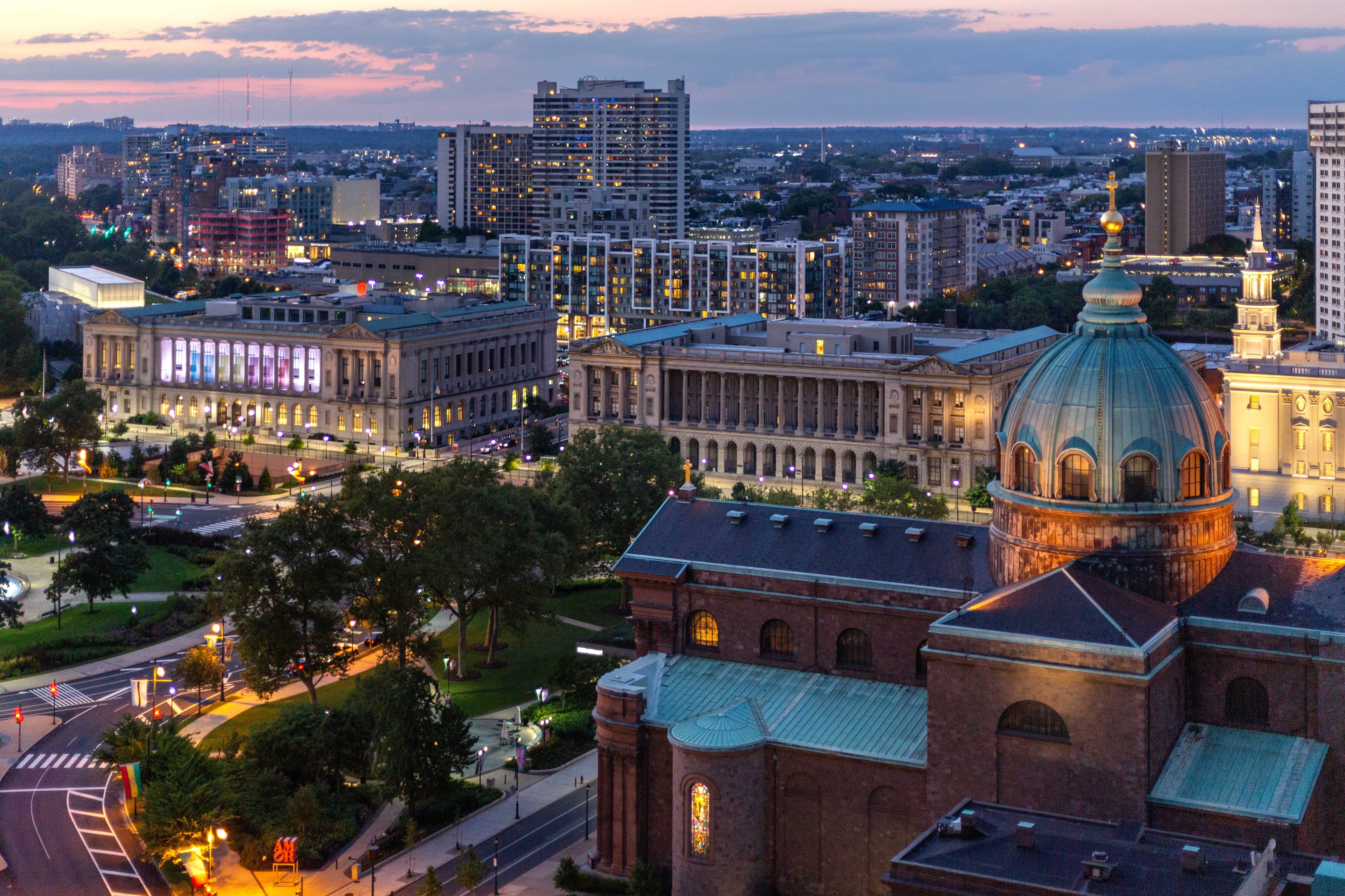 The Windsor Suites showcases a stunning view of Philadelphia's skyline at dusk.