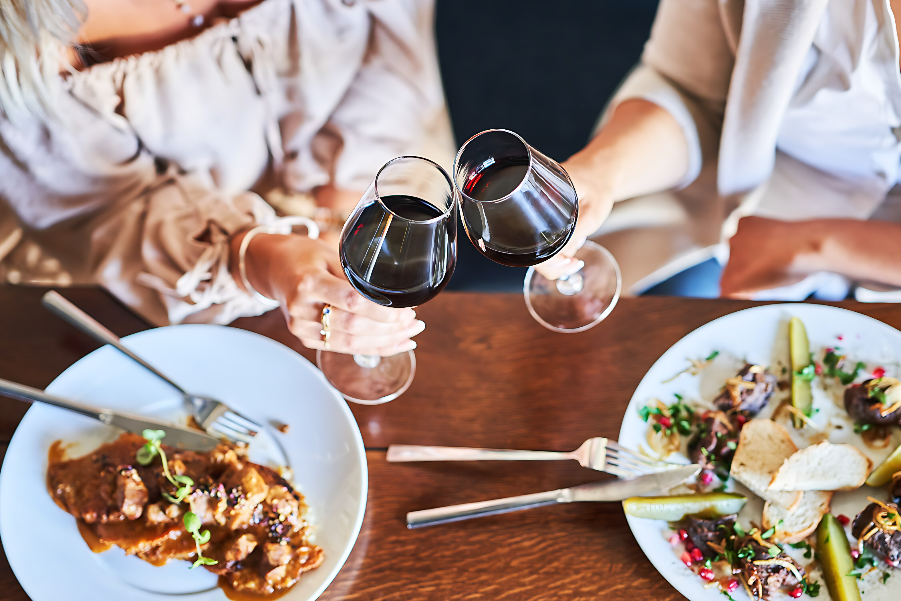 Guests enjoy a toast with red wine at The Windsor Suites in Philadelphia.