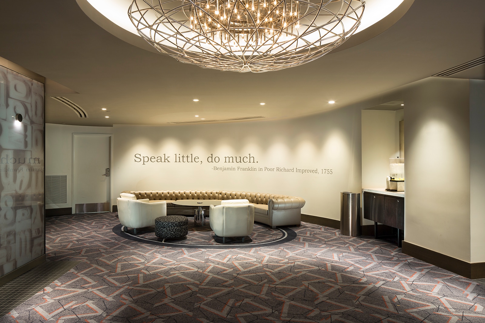 The lobby of The Windsor Suites features modern decor and a motivational quote.