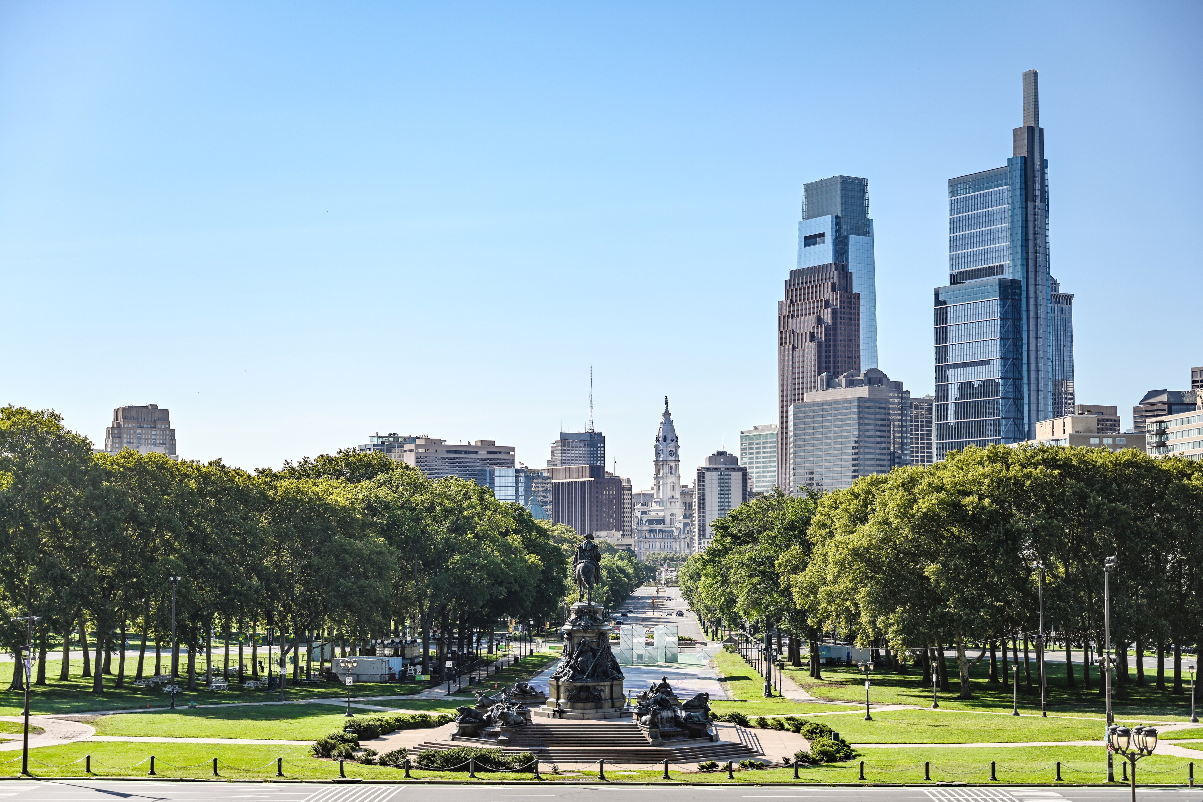 View of Philadelphia skyline from The Windsor Suites with lush greenery.