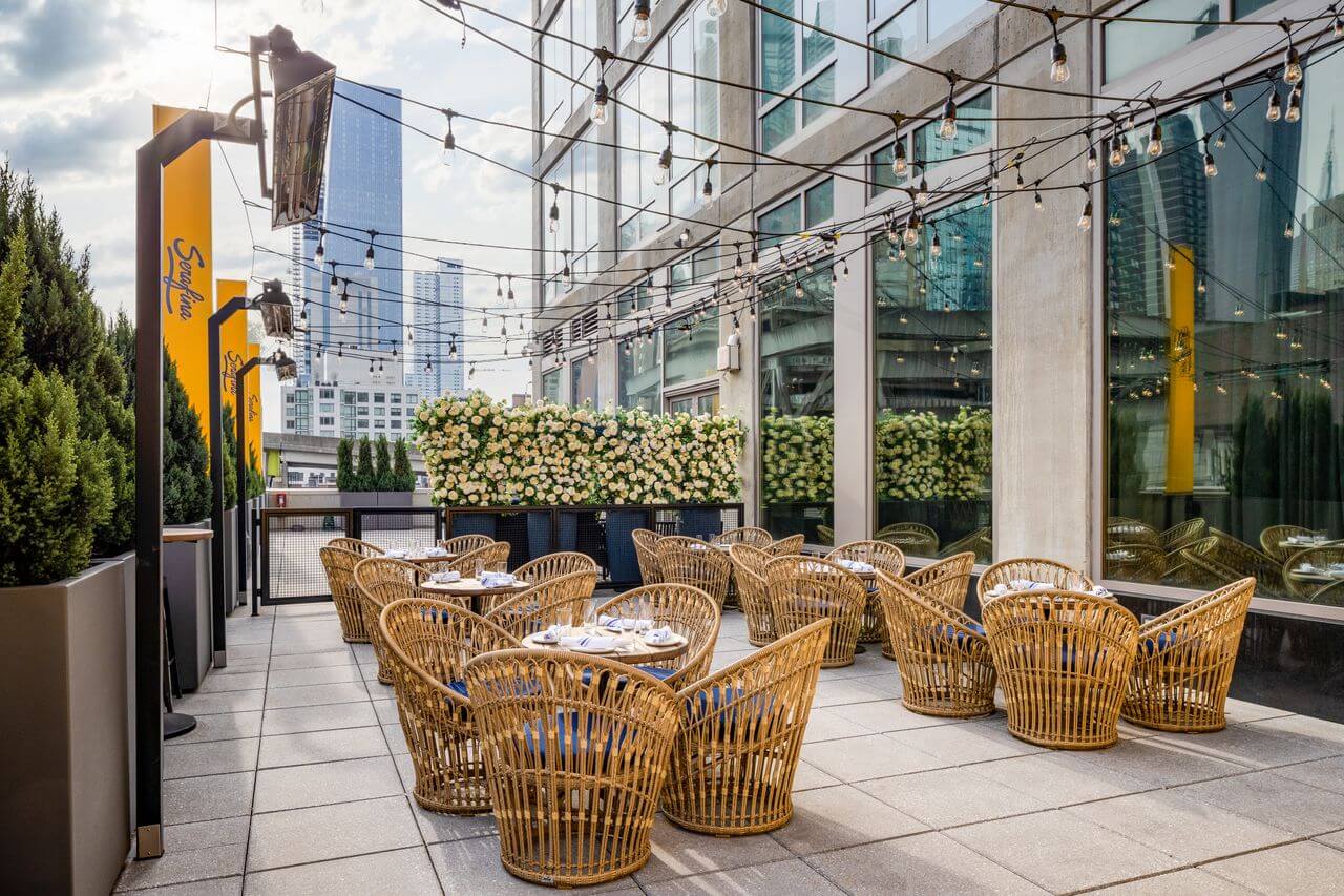 a patio dining area with wicker chairs and tables