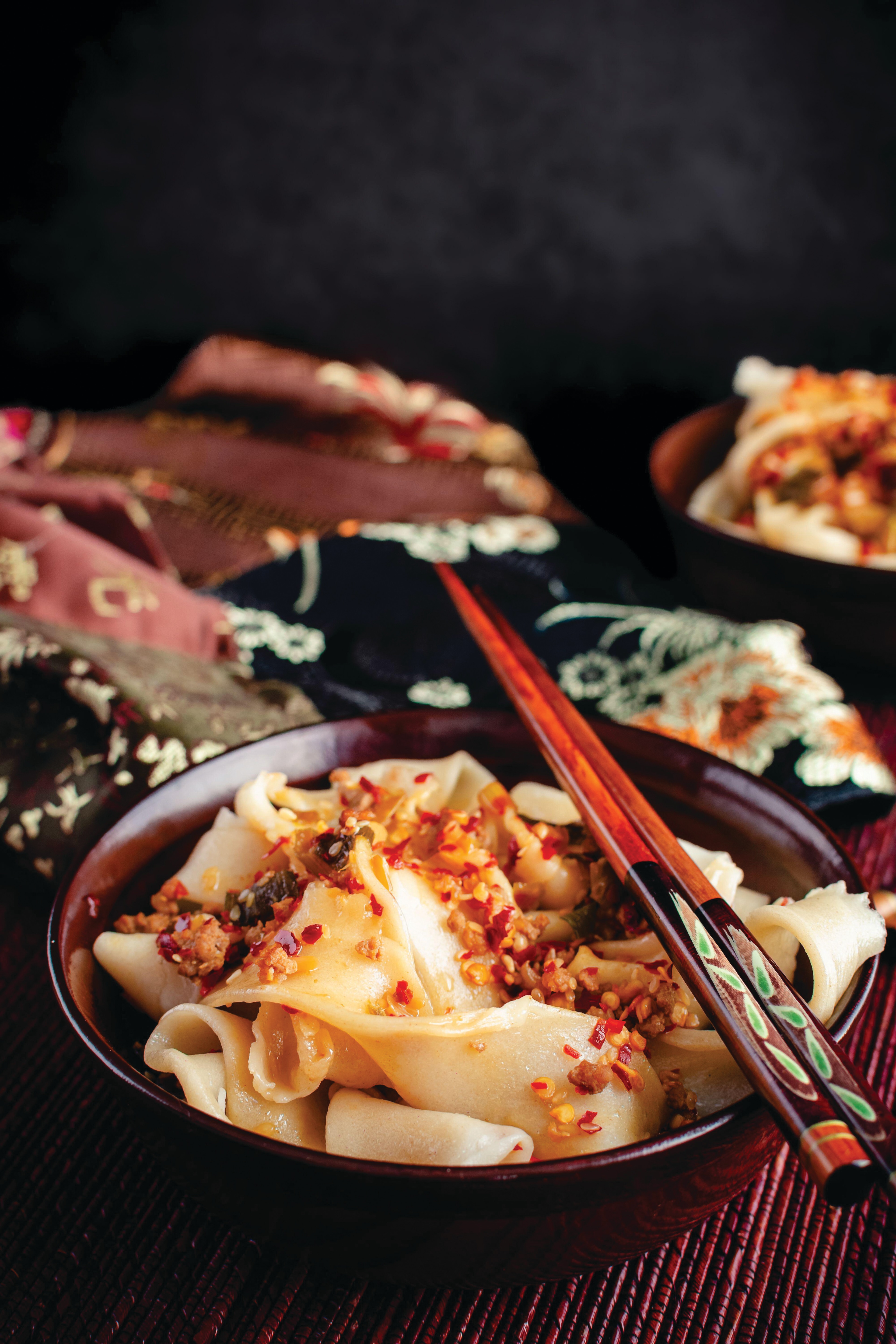 Biang biang noodles topped with a spicy chili oil sauce.