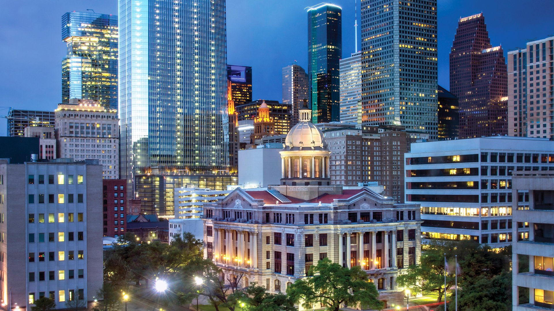 Houston's Neoclassical Harris County Courthouse and city skyscrapers.