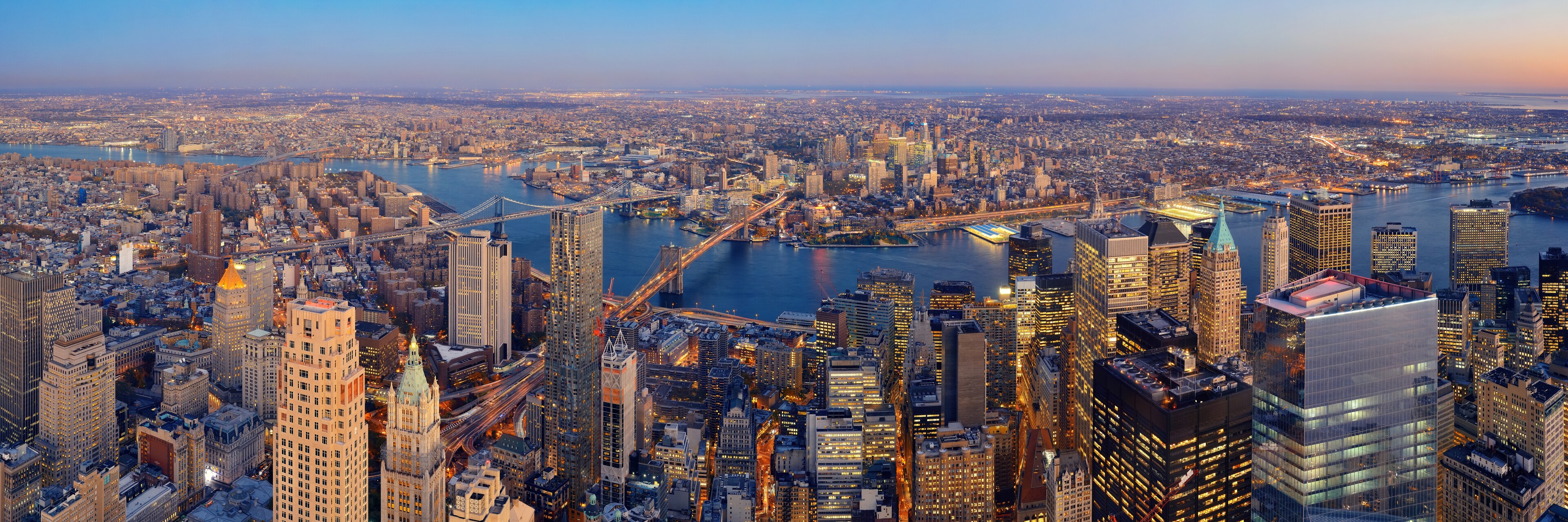 <p>A panoramic view over the glittering Manhattan skyline looks across the East River to Brooklyn.</p>