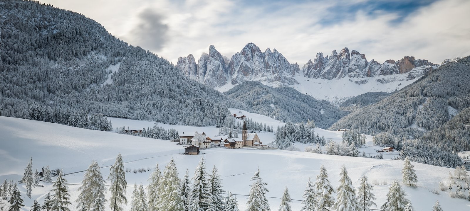 The majestic Dolomites in northeastern Italy tower over tiny villages.
