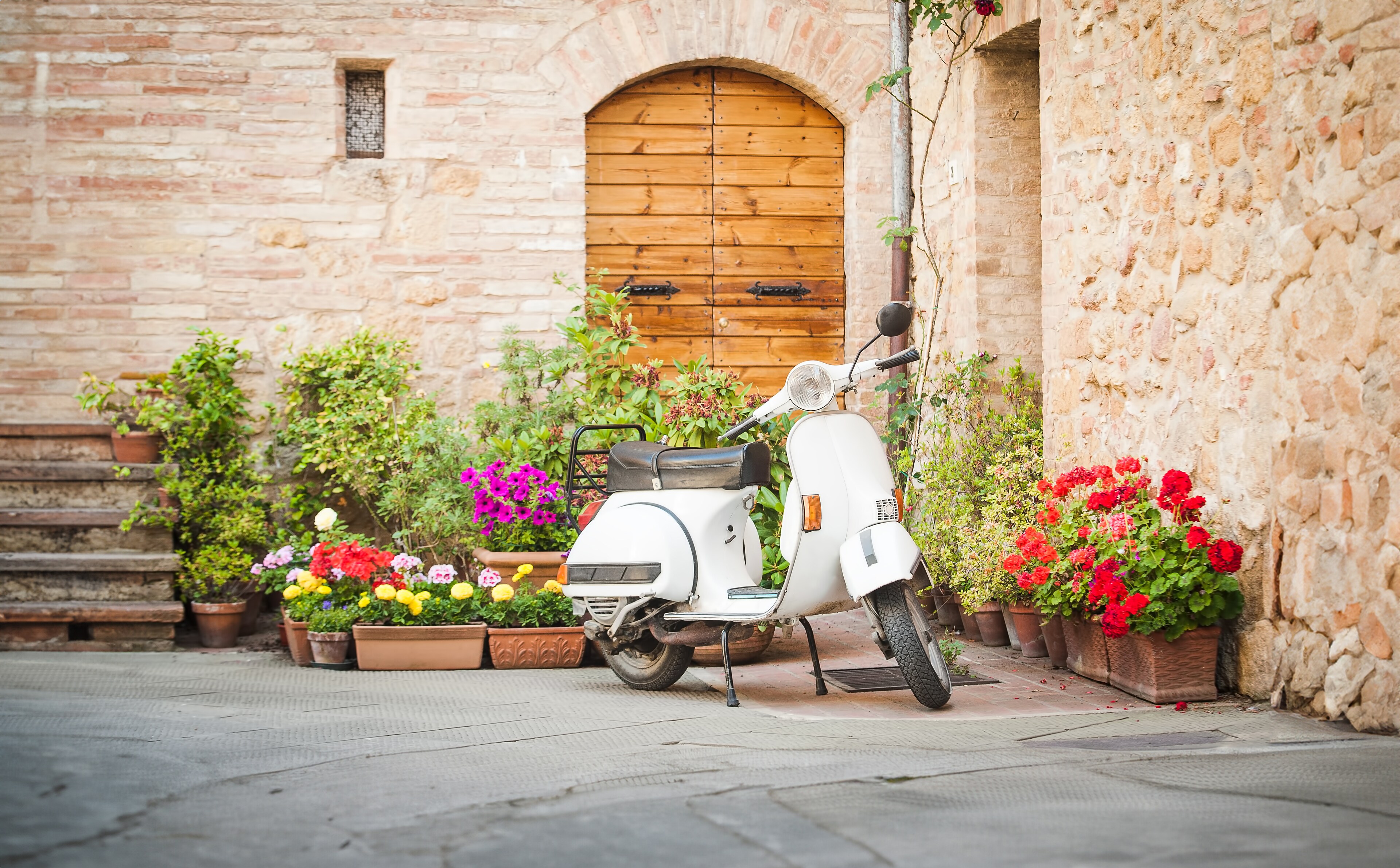 A Vespa tucked away on a pretty street.