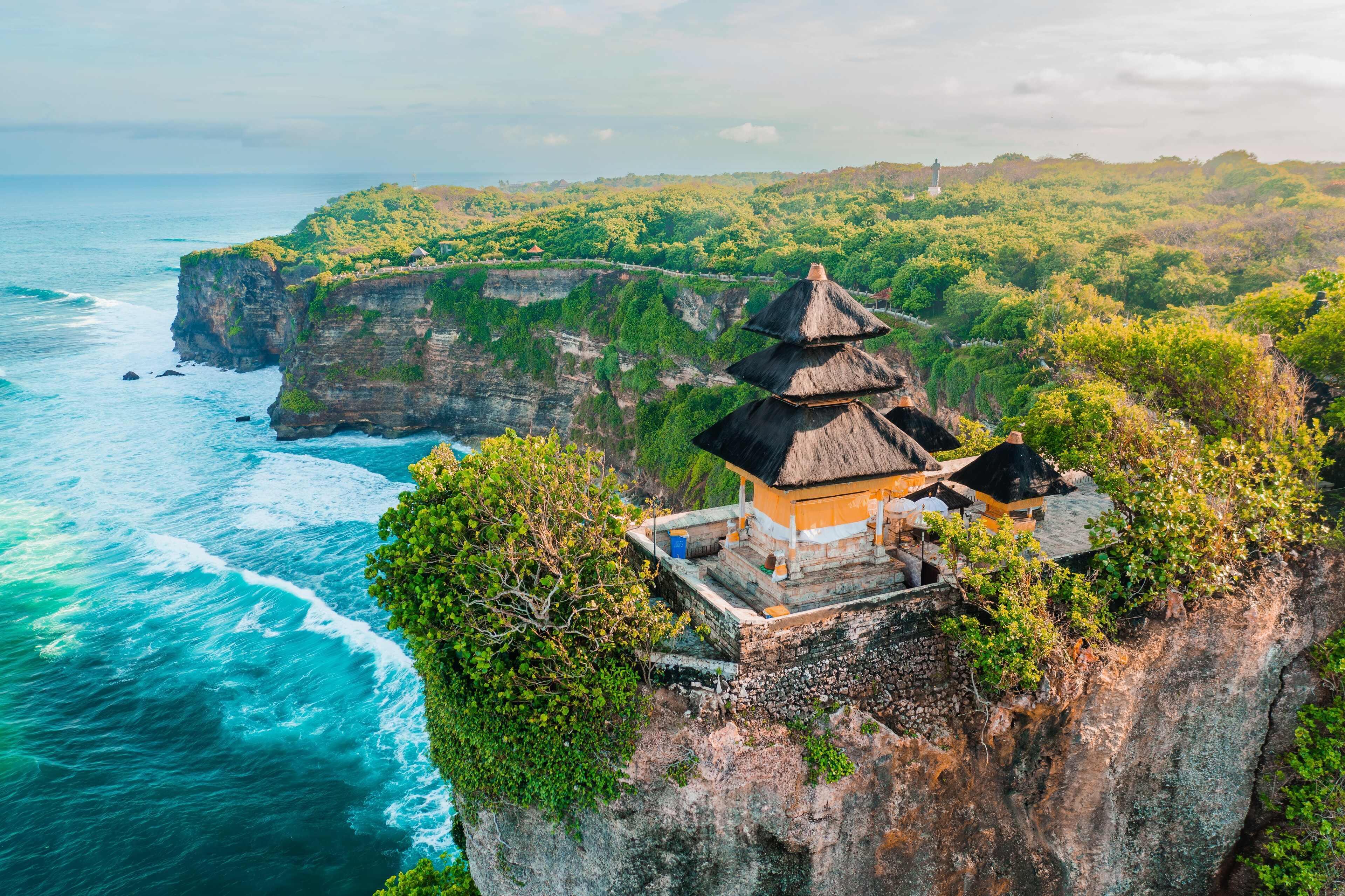 <p>Uluwatu Temple sits majestically on a clifftop towering over the ocean.</p>