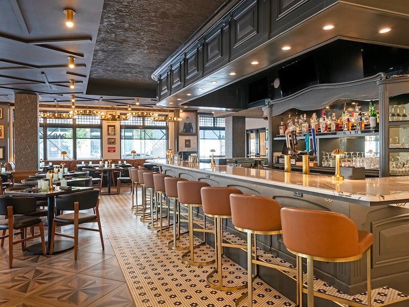 A bar with chairs and tables