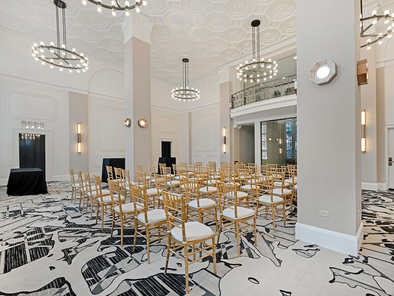 A room with many chairs and chandeliers