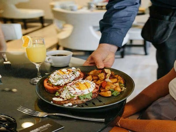 Breakfast dish at Jardenea - Avocado toast with over easy eggs and breakfast potatoes