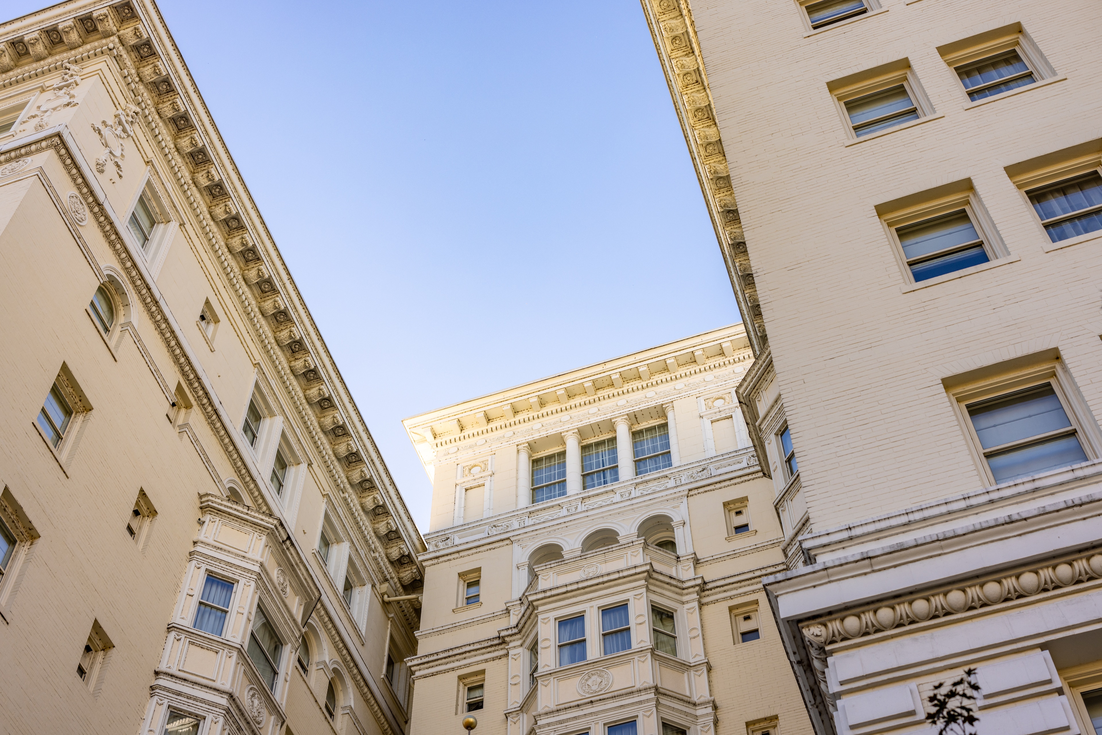 A low-angle shot of a building's exterior with ornate details and columns.