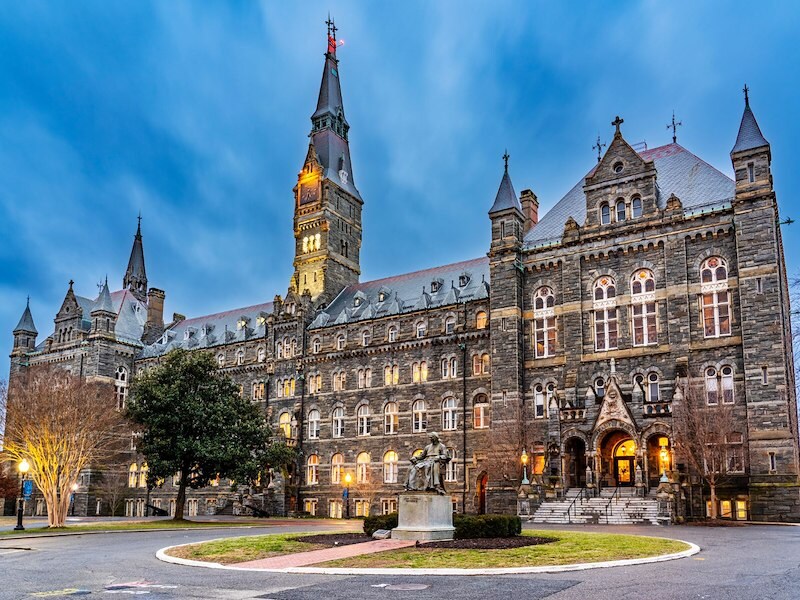 Georgetown University’s Healy Hall illuminated at dusk, showcasing Gothic architecture and historic charm