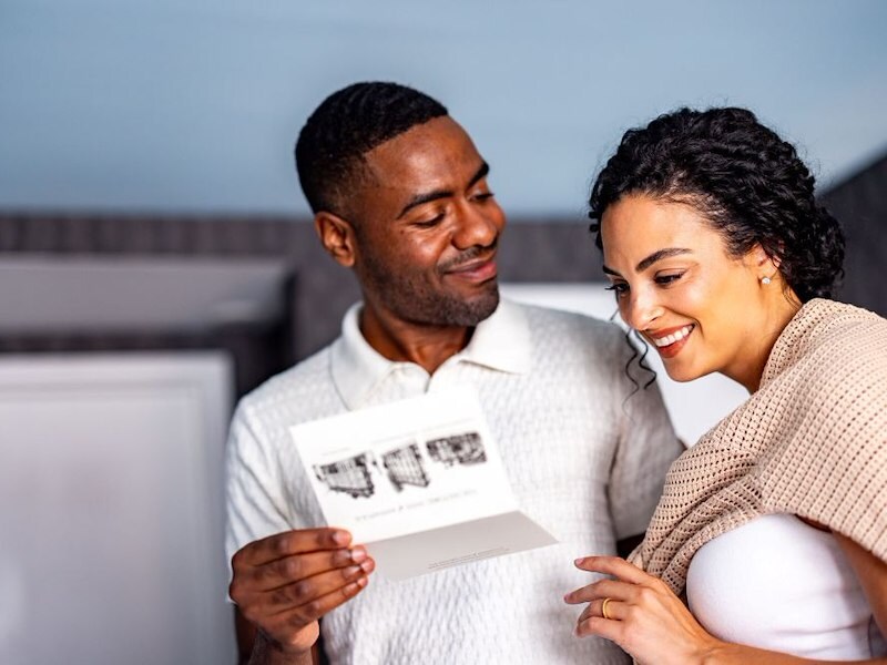 Couple reading welcome letter after checking into their room