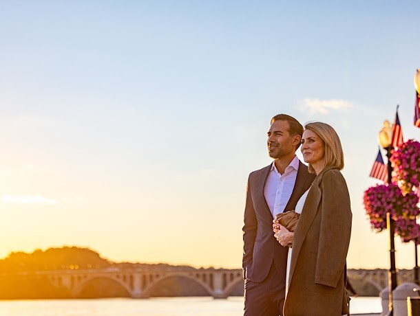 Elegant couple enjoys a romantic sunset stroll by the Potomac River
