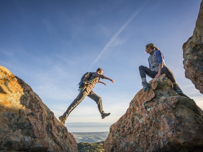 A man jumping off a rock