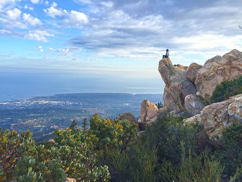 A person sitting on a rock