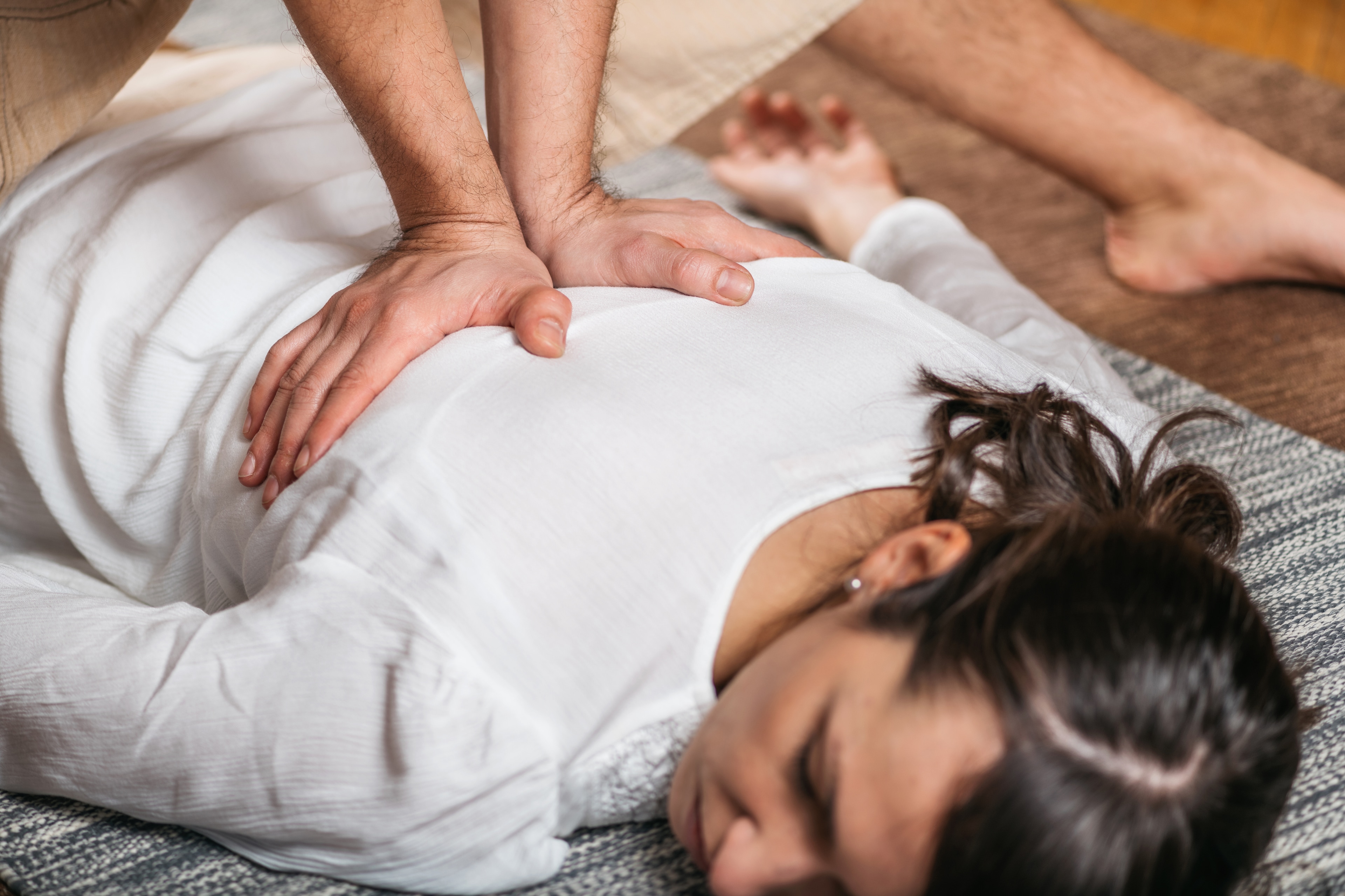 A woman receiving a massage on a table