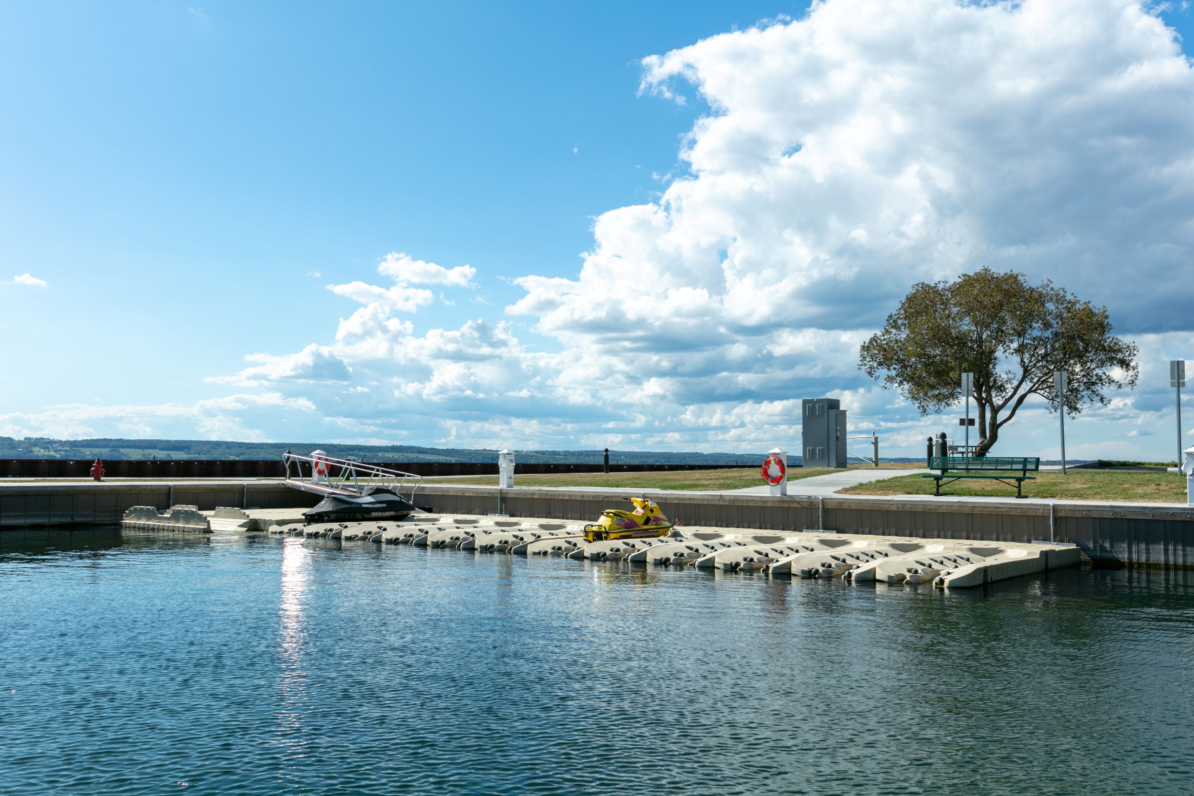 Seneca Lake Resorts features a scenic waterfront with boat docks and benches.