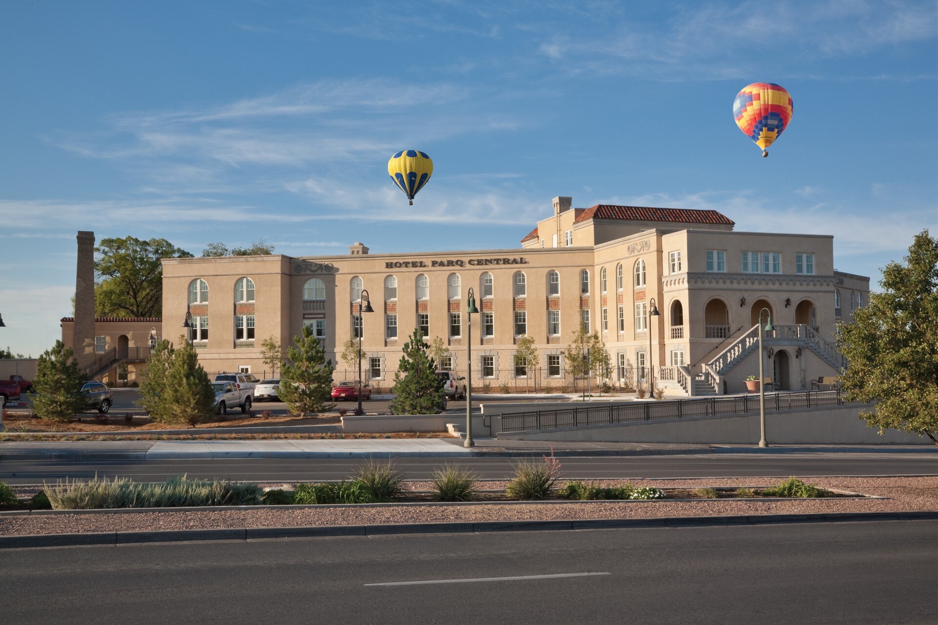 Hot air balloons flying over a building