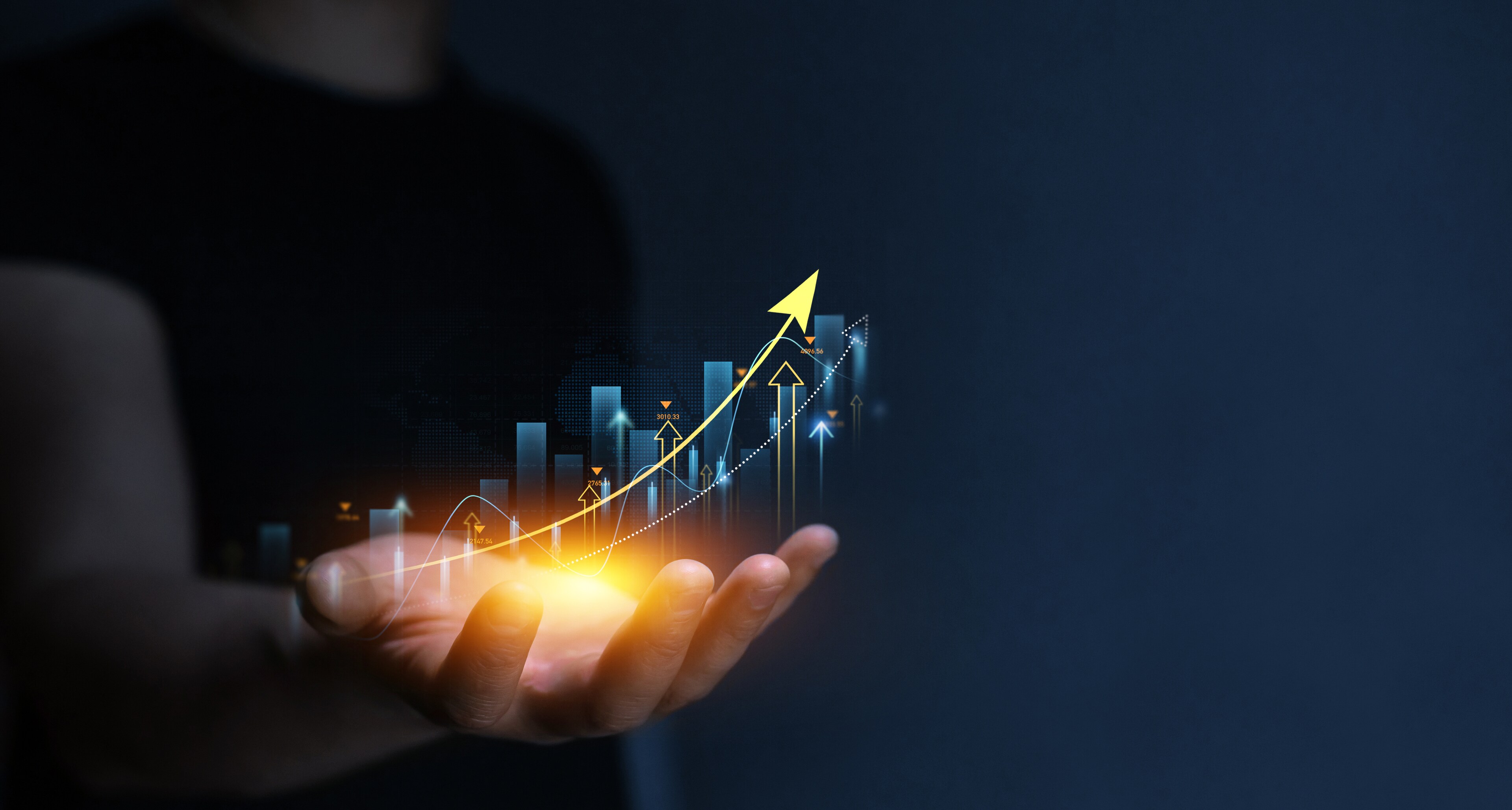 Businessman holding glowing graph chart with arrow