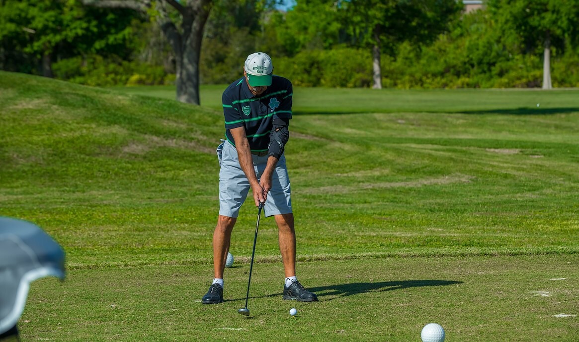 Person about to hit golf ball with putter