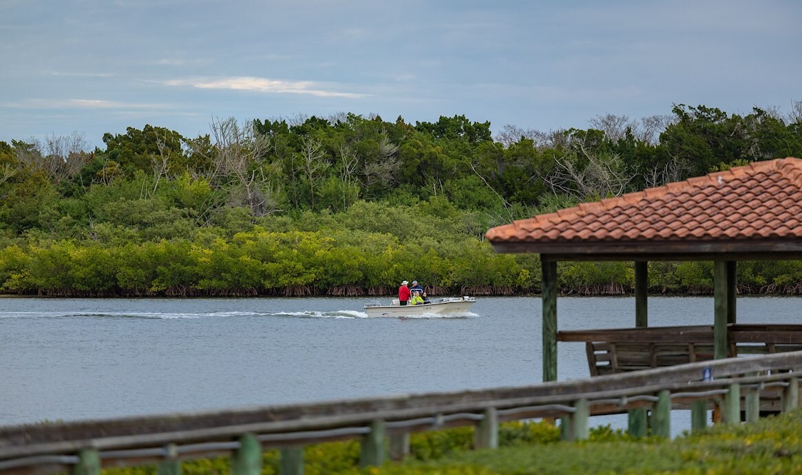 Small boat on the water with people fishing