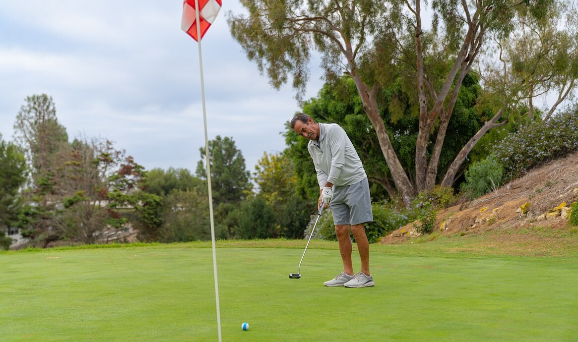 Person hitting a golf ball