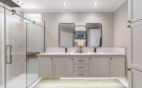 Bright bathroom with dual sinks and walk in shower